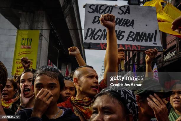 Filipino leftist protesters march against President Rodrigo Duterte on the streets on November 30, 2017 in Manila, Philippines. After announcing his...