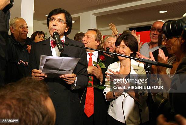 Chairman of Belgium's Socialist Party Elio Di Rupo gives a speech as Michel Daerden and Laurette Onkelinx look on at the PS elections evening in...