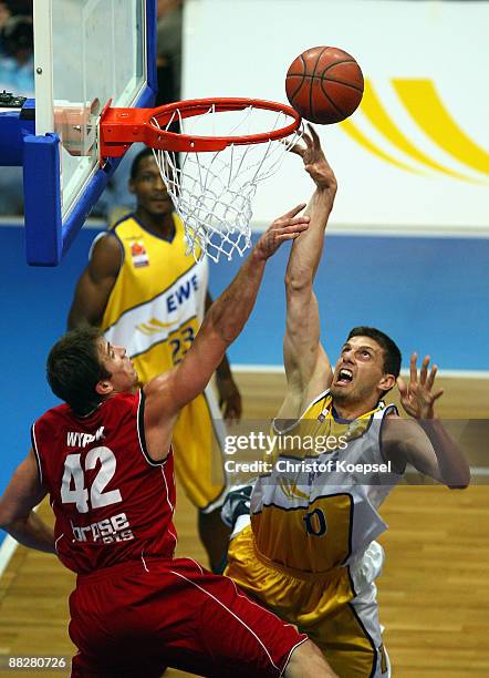 Milan Majstorovic of Oldenburg scores against Beckham Wyrick of Brose Baskets Bamberg during the Basketball Bundesliga Play-Off match between EWE...