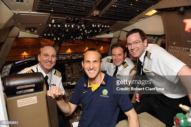 Australian goalkeeper Mark Schwarzer poses with the Qantas flight crew, captain Mark Hempenstall, First officer, Ben Smith and first officer Anthony...