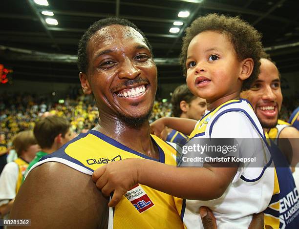 Rickey Paulding of Oldenburg celebrates the 88-85 victory with his son after the Basketball Bundesliga Play-Off match between EWE Baskets Oldenburg...
