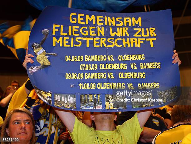 Fan of Oldenburg holds a banner during the Basketball Bundesliga Play-Off match between EWE Baskets Oldenburg and Brose Baskets Bamberg at the EWE...
