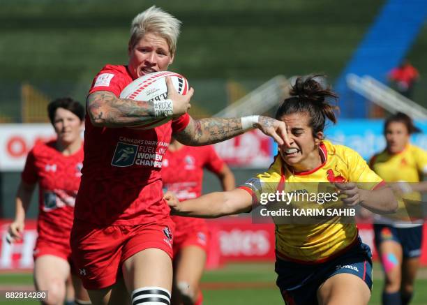 Canada's Jen Kish is tackled by Spain's Maria Ribera during the Women's Sevens World Dubai Series rugby union match in the Gulf emirate of Dubai on...