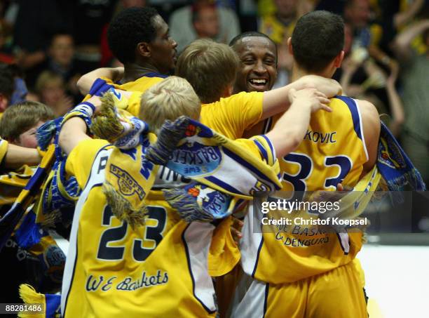 Rickey Pauldin, Je'Kel Foster and Miladin Pekovic of Oldenburg celebrate the 88-85 victory and the qualifying for the final after the Basketball...