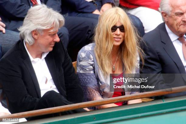 Former tennis player Bjorn Borg and a guest attend the French Open at Stade Roland Garros on June 7, 2009 in Paris, France.