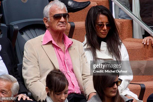 Actor Jean-Paul Belmondo and a guest attend the French Open at Stade Roland Garros on June 7, 2009 in Paris, France.