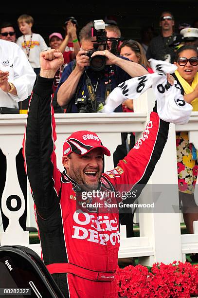 Tony Stewrat, driver of the Office Depot/Old Spice Chevrolet, celebrates in Victory Lane after winning the NASCAR Sprint Cup Series Pocono 500 on...