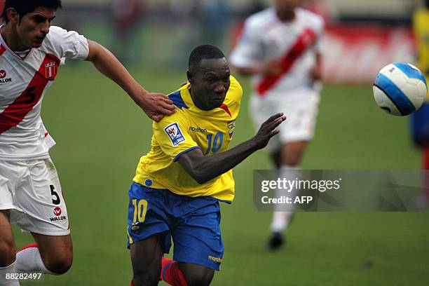 Walter Ayovi from Ecuador vies for the ball with Peru's Carlos Zambrano during their FIFA World Cup South Africa-2010 qualifier football match at the...
