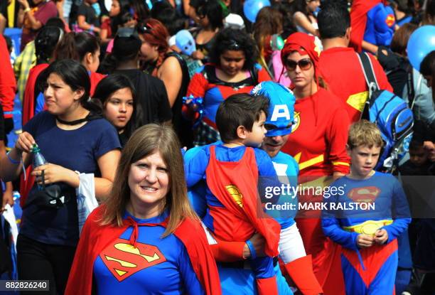 Superman characters join the crowd of 1,580 costumed superheroes during the successful attempt to break the Guinness World Record for the largest...