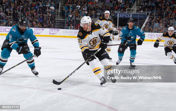 Jordan Szwarz of the Boston Bruins skates with the puck against Joel Ward of the San Jose Sharks at SAP Center on November 18, 2017 in San Jose,...