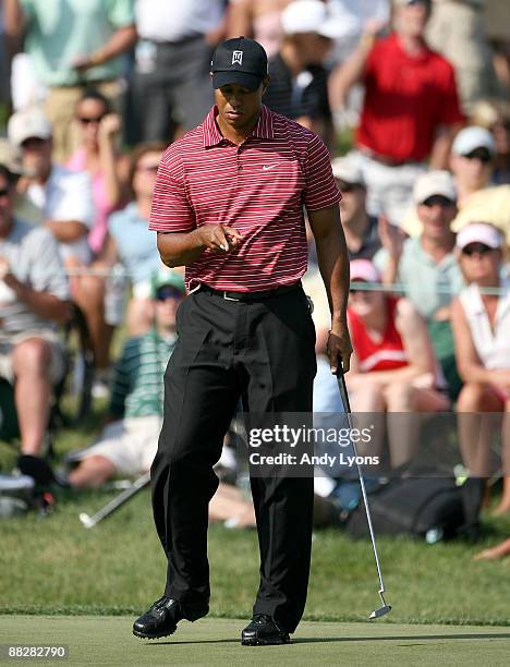 Tiger Woods watches his birdie putt fall in on the 17th hole during the final round of the Memorial Tournament on June 7, 2009 at the Muirfield...