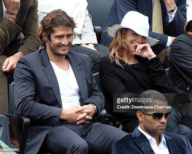 Former Football World Champion Bixente Lizarazu And French actress Claire Keim watch the action during the Men's Singles Final match Robin Soderling...