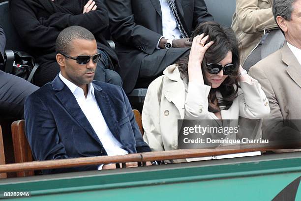 Basketball player Tony Parker and French Actress Isabelle Adjani watch the action during the Men's Singles Final match Robin Soderling of Sweden and...