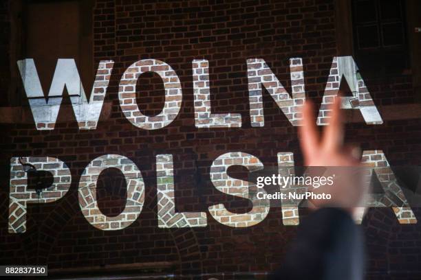 Sign 'Free Poland' is screened during a protest at the Main Square against government plans for sweeping changes to Polands judicial system. Krakow,...