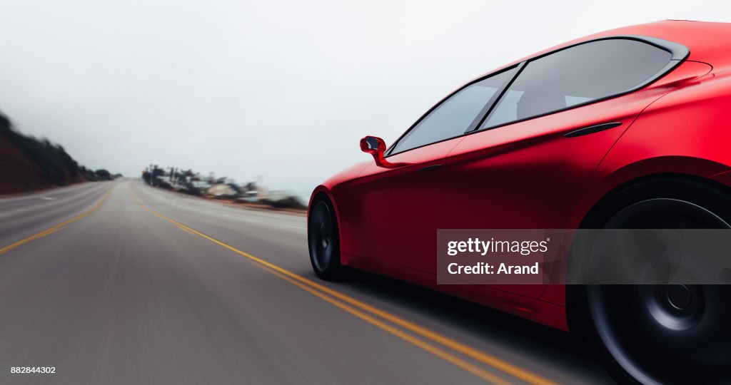 Car driving on a road by sea