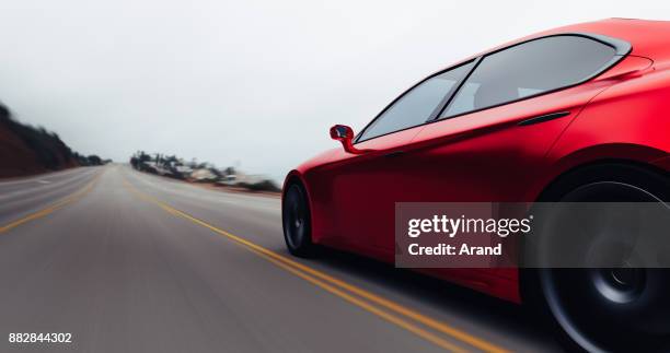 car driving on a road by sea - luxury sports car stock pictures, royalty-free photos & images