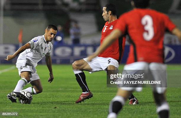Algeria's Karim Ziani attempts to dribble as Egypt's Mohammed Aboutrika defends during their 2010 World Cup African zone Group C qualifying football...