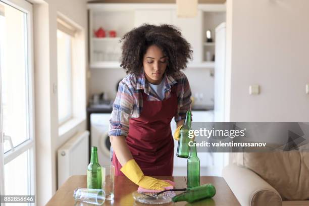 young woman cleaning kitchen - cleaning up after party stock pictures, royalty-free photos & images