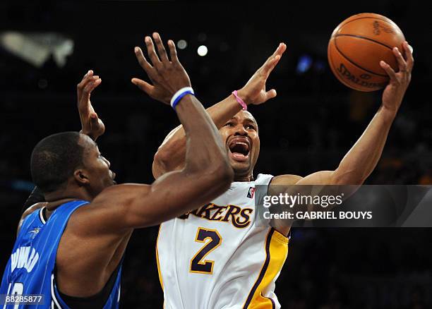 Los Angeles' Lakers guard Derek Fisher scores in front of Orlando Magic's center Dwight Howard during the Game 2 of the NBA final between Los Angeles...