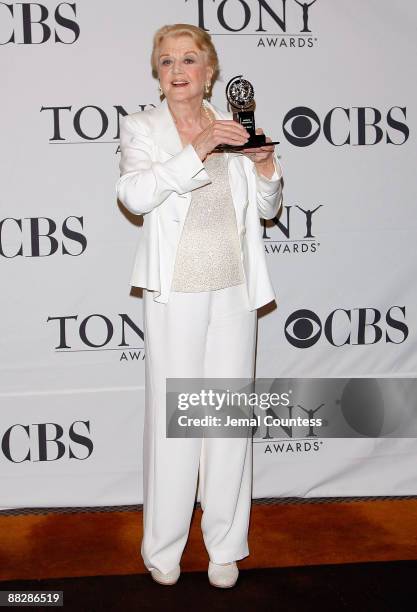 Actress Angela Lansbury poses with the Tony for best performance by a featured actress in a play for 'Blithe Spirit' in the press room at the 63rd...