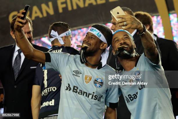 Leonardo Moura and Michel of Gremio celebrate with their medals after winning the second leg match between Lanus and Gremio as part of Copa...