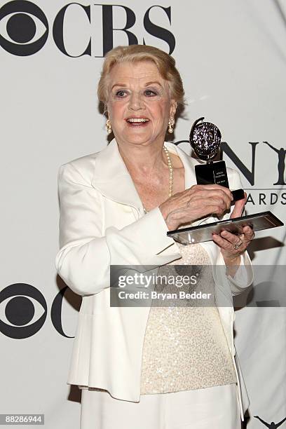 Actress Angela Lansbury poses with her award for best performance by a featured actress in a play for 'Blithe Spirit' in the pressroom at the 63rd...