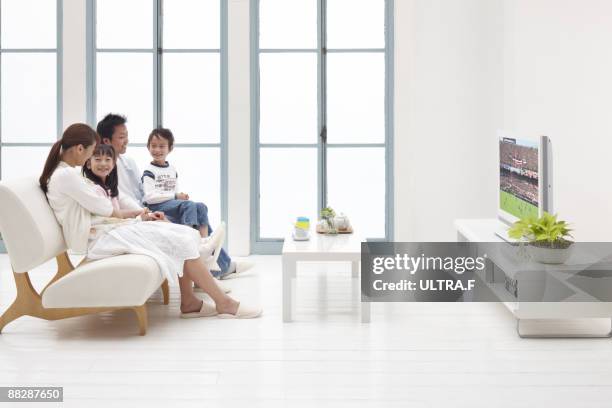 a family relaxing in the living room. - kids watching tv no adult stock pictures, royalty-free photos & images