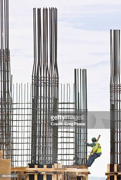 construction workers at high-rise building site. - tige métallique photos et images de collection