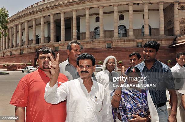 The first Maoist politician to be elected to the Indian Parliament Kameshwar Baitha and his wife show a victory sign as they arrive with supporters...