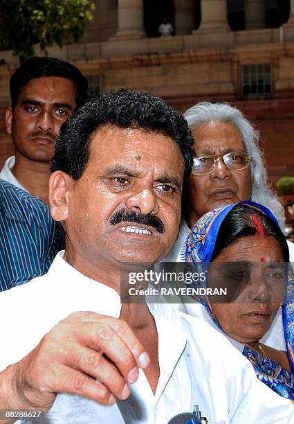 India's first elected Maoist to the Indian Parliament Kameshwar Baitha and his wife speak to media representatives as they arrive with supporters at...