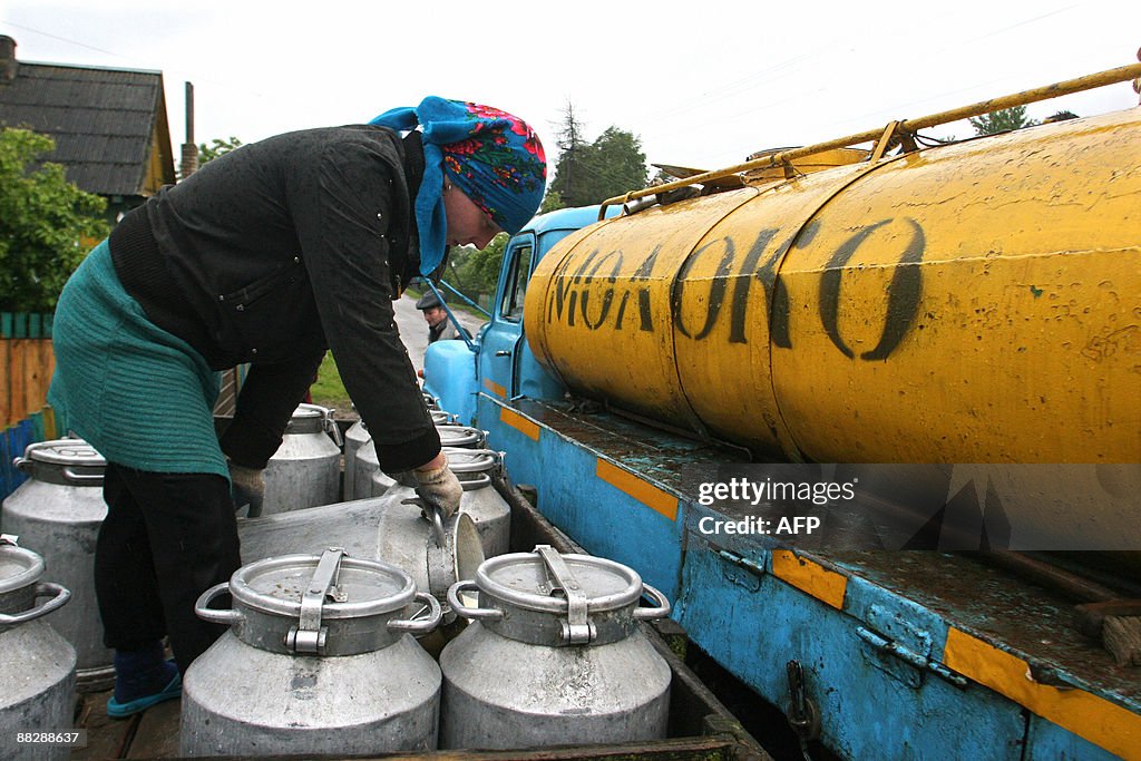 Farmers on a cooperative fill a milk tan