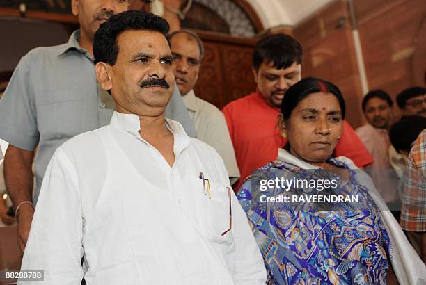 India's first elected Maoist to the Indian Parliament Kameshwar Baitha and his wife pose as they arrive with supporters at Parliament House in New...