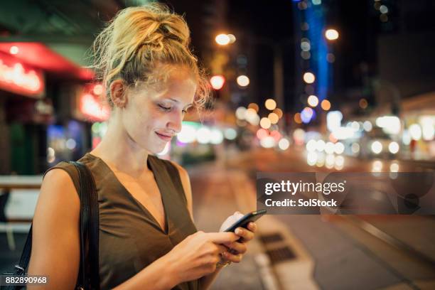 young woman texting - surfers paradise australia stock pictures, royalty-free photos & images