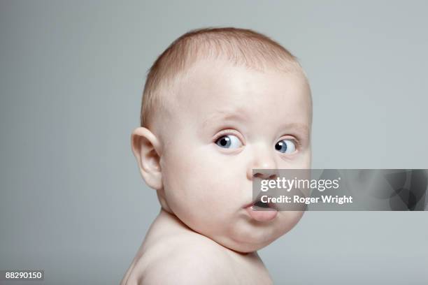 portrait of baby boy looking to the side - sólo bebés fotografías e imágenes de stock