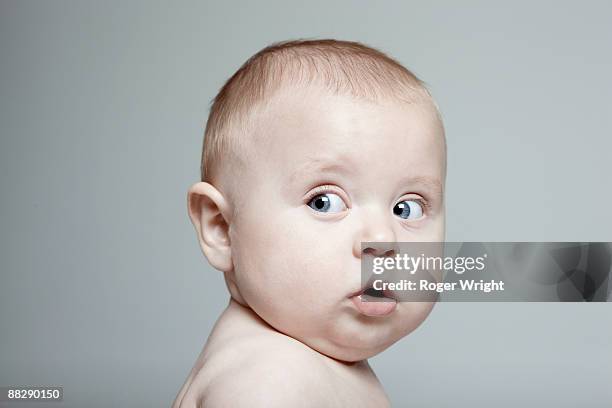 portrait of baby boy looking to the side - boy looking over shoulder stock pictures, royalty-free photos & images