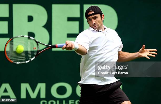 Benjamin Becker of Germany plays a forehand during his first round match against Victor Hanescu of Rumania on day 1 of the Gerry Weber Open at the...