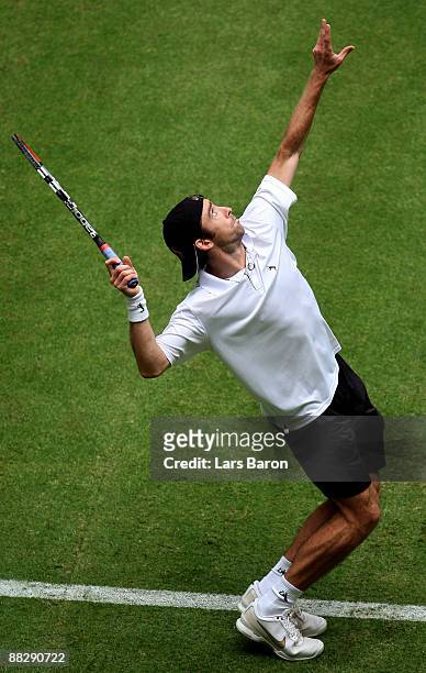 Benjamin Becker of Germany serves during his first round match against Victor Hanescu of Rumania on day 1 of the Gerry Weber Open at the Gerry Weber...