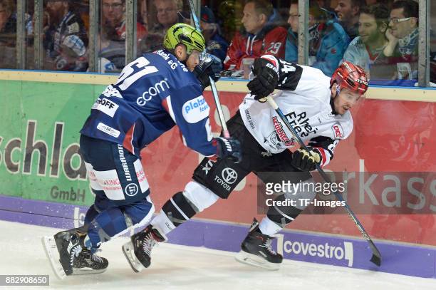 Chad Bassen of Iserlohn Roosters and Jean-Francois Boucher of Koeln battle for the ball during the DEL match between Iserlohn Roosters and Kölner...
