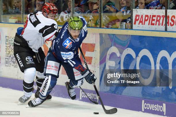 Shawn Lalonde of Koeln , Chris Brown of Iserlohn Roosters battle for the ball during the DEL match between Iserlohn Roosters and Kölner Haie on...