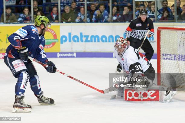 Jack Combs of Iserlohn Roosters and Justin Peters of Koeln battle for the ball during the DEL match between Iserlohn Roosters and Kölner Haie on...