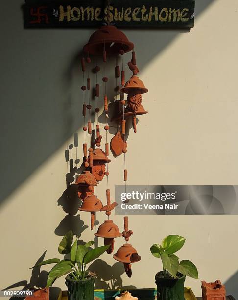terracotta wind chime and pothos in the home balcony/balcony decor - epipremnum stock pictures, royalty-free photos & images