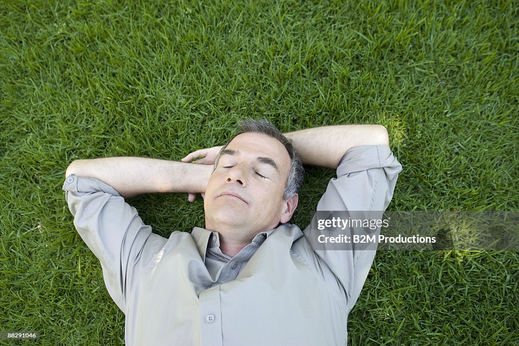 Mature man lying in the grass