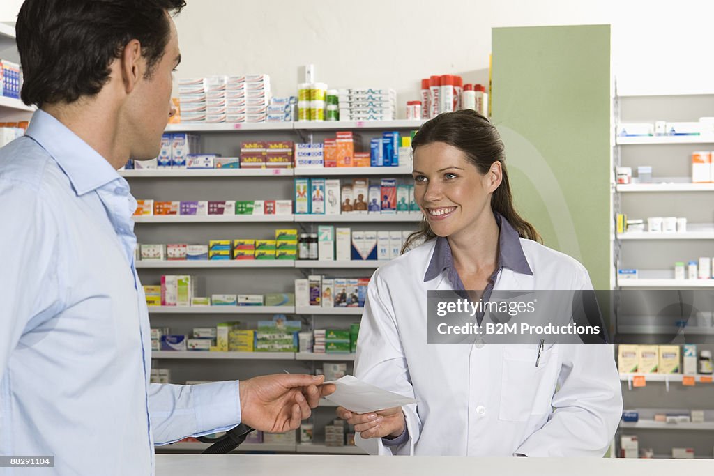 Female pharmacist with male client