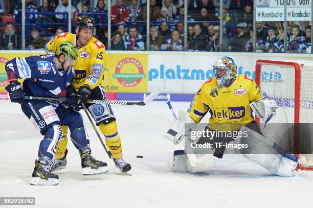 Denis Shevyrin of Iserlohn Roosters and Mikko Vainonen of Krefeld Pinguine and Dimitri Paetzold of Krefeld Pinguine battle for the ball during the...