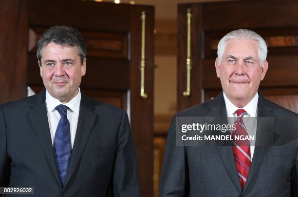 Secretary of State Rex Tillerson and Germany's Foreign Minister Sigmar Gabriel arrive to pose for photos ahead of a bilateral at the State Department...