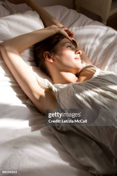 streching woman - getting out of bed stock-fotos und bilder