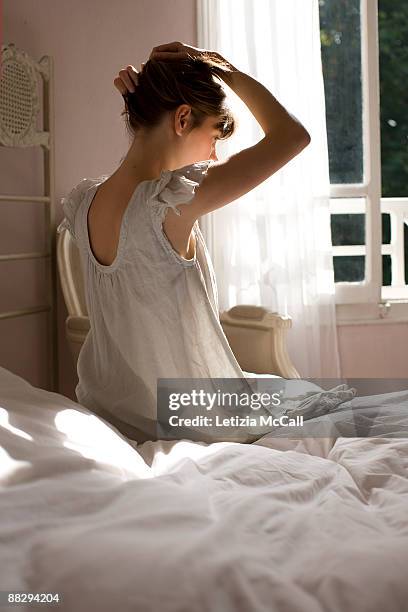 woman with hands in her hair - bedroom curtains stock pictures, royalty-free photos & images