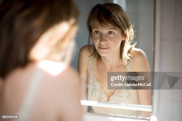 woman in the mirror - mirror image stock-fotos und bilder