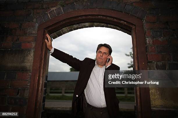 Nick Griffin MEP, leader of The British National Party, talks to the media on his phone in his hometown of Welshpool after winning the North West...