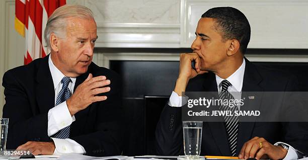 President Barack Obama listens as Vice President Joe Biden makes remarks during a meeting with his Cabinet to discuss the implementation of the...